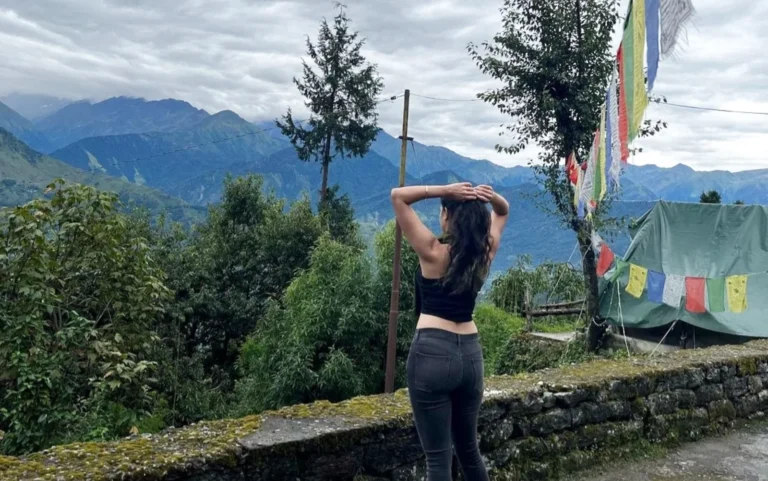 a girl standing the beautiful view of munsiyari mountains